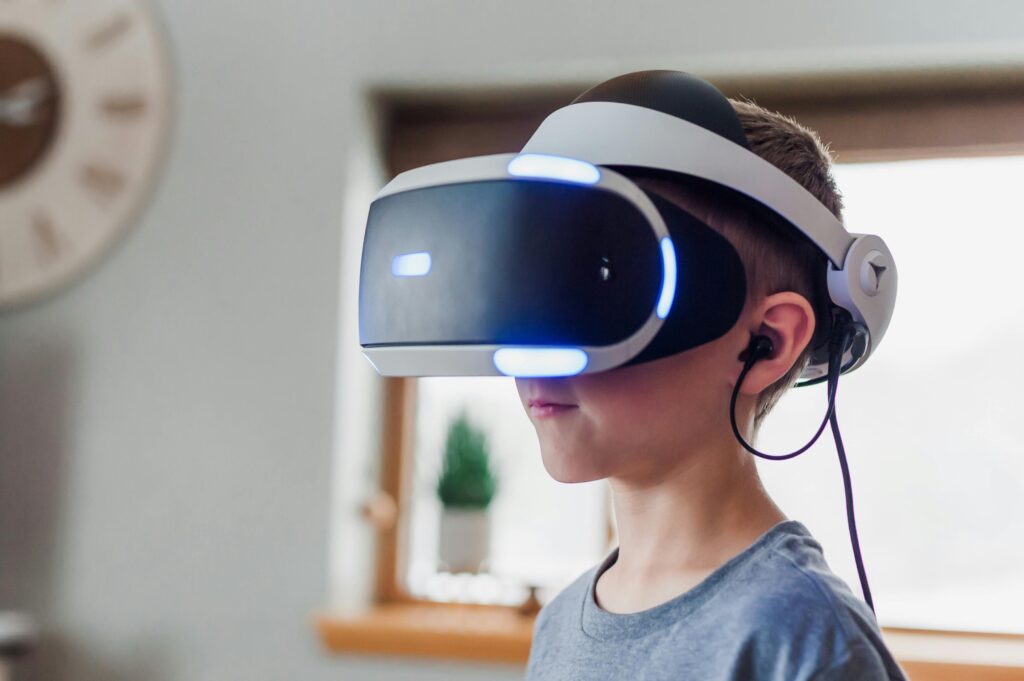 Young boy wearing a VR headset immersed in a virtual reality experience at home.